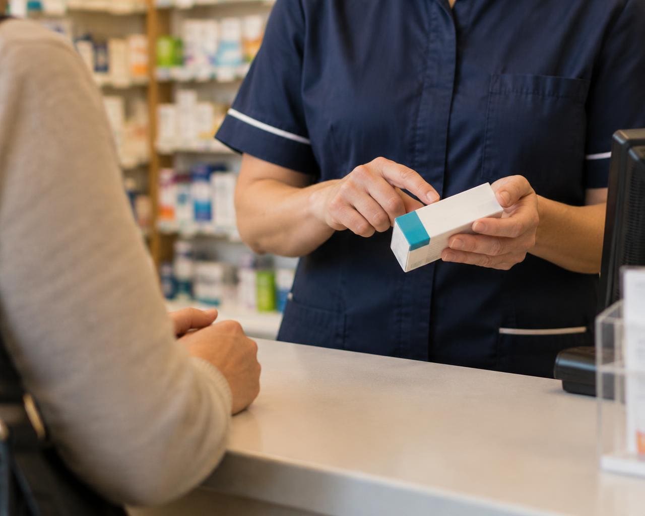 A pharmacist explaining a medicine to a patient at The Martin Pharmacy
